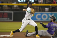 Arizona Diamondbacks shortstop Geraldo Perdomo throws to first base after forcing out Colorado Rockies' Charlie Blackmon at second during the first inning of a baseball game Thursday, June 1, 2023, in Phoenix. The Rockies' Jurickson Profar was out at first to complete the double play. (AP Photo/Darryl Webb)