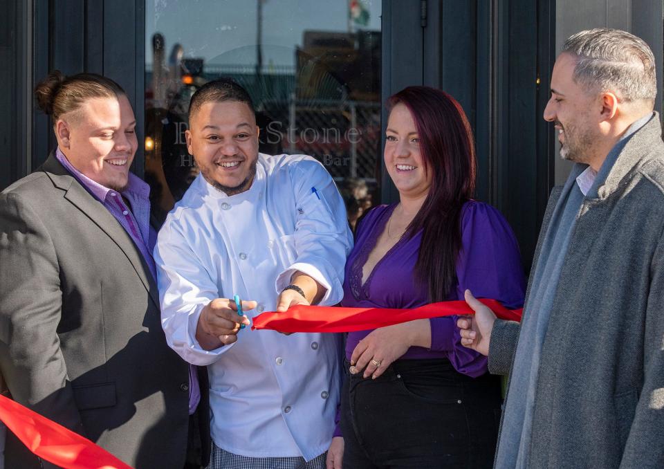 Chef Darien Moronta, center, cuts the ceremonial ribbon with Blackstone Herbs & Martini Bar owners Gian and Bryanna Ranucci Wednesday, February 1, 2023. City Manager Eric D. Batista, right, attended the Green St. opening along with other city officials.