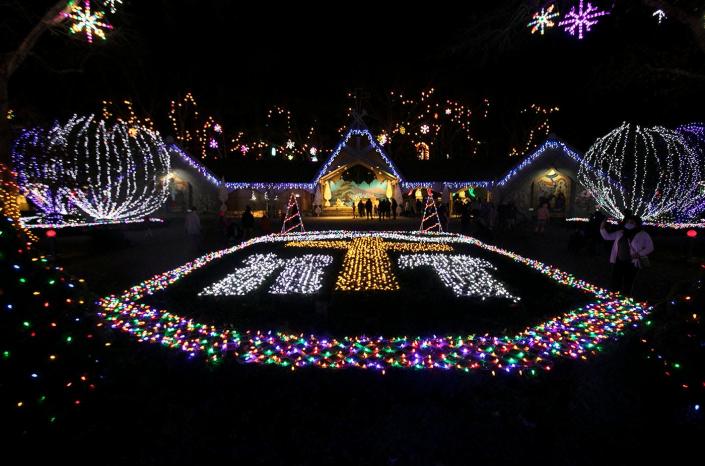 An enormous cross made of Christmas lights is one of the many elaborate light displays at La Salette Shrine in Attleboro on Sunday, Nov. 29, 2020.
