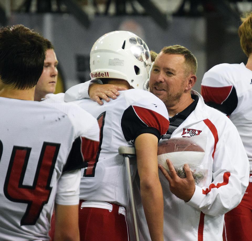 Coach Chad Garrow greets his players following a 41-31 loss to Sioux Falls Washington in the 2016 Class 11AAA state football title game.