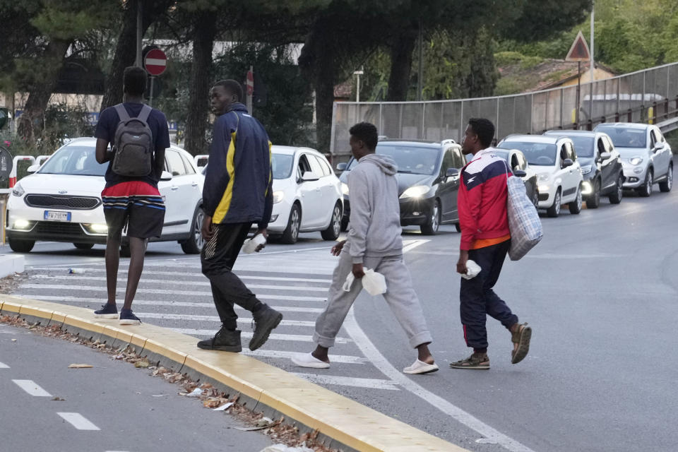 Migrants walk towards a station to board a bus directed to Marseille, France, in Rome, Tuesday, Sept. 12, 2023. Ten years after Pope Francis made a landmark visit to the Italian island of Lampedusa to show solidarity with migrants, he is joining Catholic bishops from around the Mediterranean this weekend in France to make the call more united, precisely at the moment that European leaders are again scrambling to stem the tide of would-be refugees setting off from Africa. (AP Photo/Gregorio Borgia)