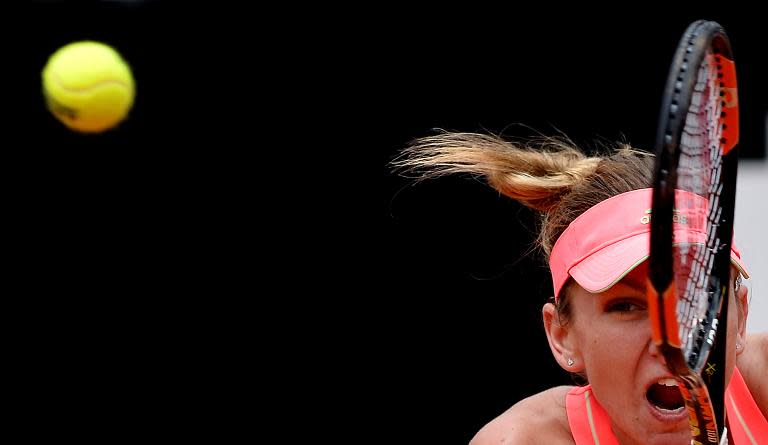 Simona Halep of Romania hits a return to Spain's Carla Suarez Navarro during their semi final match of the WTA Tennis Open tournament at the Foro Italico, on May 16, 2015 in Rome