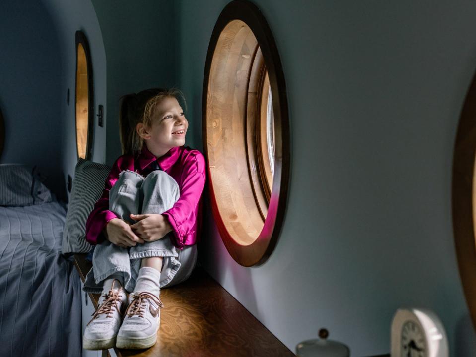 Lujzi sitting next to a window in the Jet House.