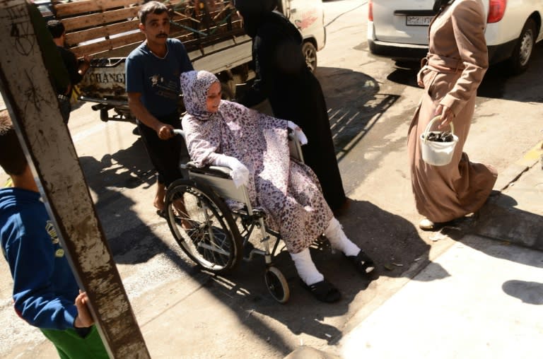 A wounded Syrian woman is wheeled into a hospital after she was hit by mortar shells that targeted Aleppo's government controlled Aziziyah and Suleimaniyah neighbourhoods on September 28, 2016