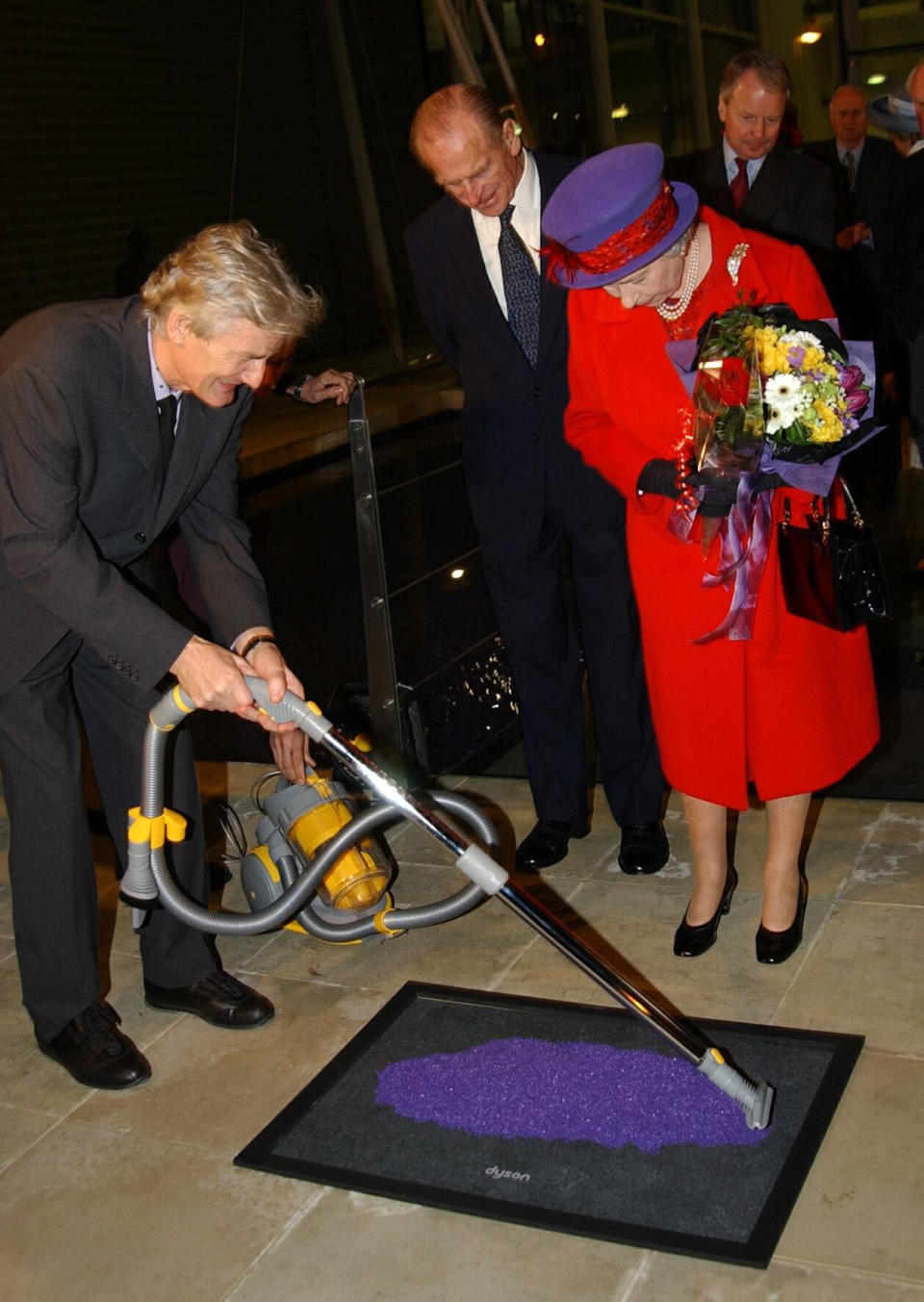 The Queen and the Duke of Edinburgh watch James Dyson unveil a plaque at the vacuum cleaner maker's Malmesbury factory near Chippenham in Wiltshire, during a visit to the town. She travelled by scheduled train with the Duke of Edinburgh for a day of engagements.  * around the area. 