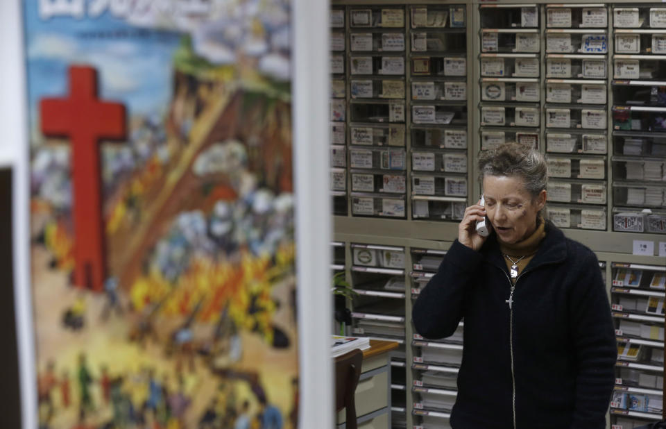 Karen Short, wife of the Australian missionary John Short talks on the phone inside the Christian Book Room in Hong Kong Wednesday, Feb. 19, 2014. Short went to North Korea in a regular tour group last week with one other person, who returned to China on Tuesday and told the family Short had been questioned and arrested at his Pyongyang hotel on Sunday, according to a statement released by the family. (AP Photo/Kin Cheung)
