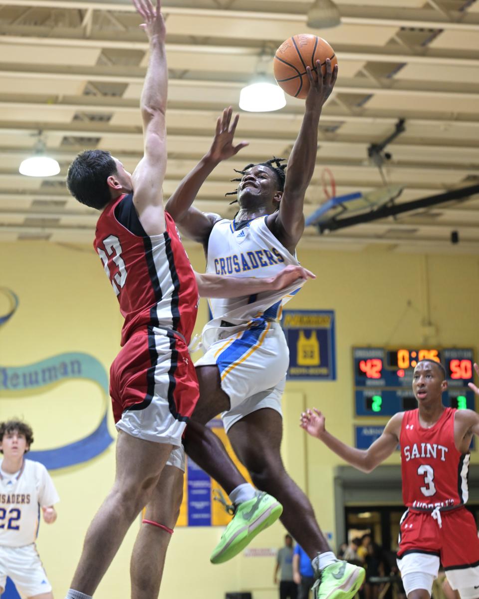 Cardinal Newman shooting guard Jermaine Council (1) goes high for a shot against Saint Andrews on Jan. 30, 2024.