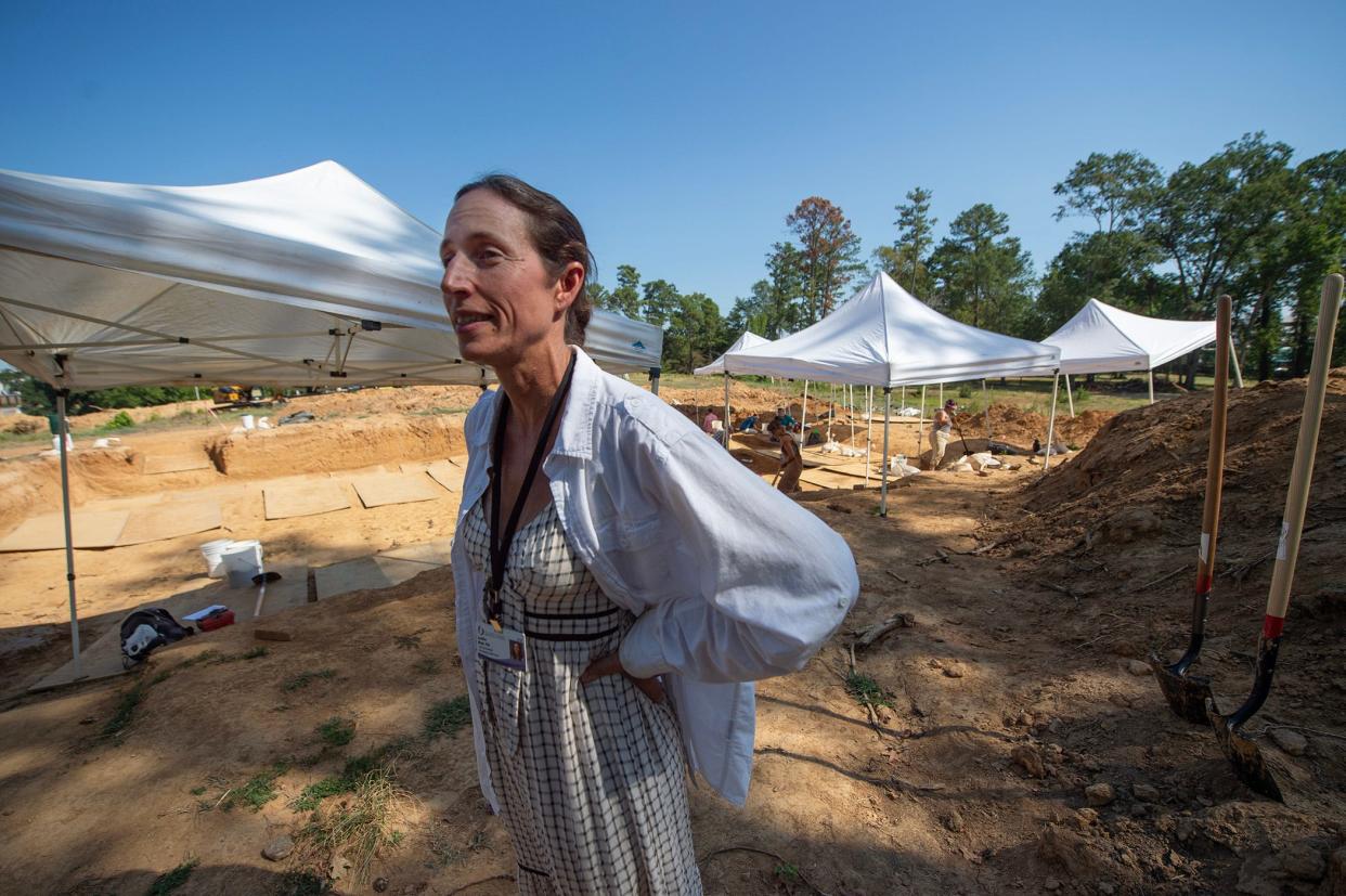 Jennifer Mack, lead bioarcheologist for the Asylum Hill Project at the University of Mississippi Medical Center, explains the ongoing excavation of as many as 7,000 graves on Asylum Hill, the one remaining undeveloped area of the UMMC main campus in Jackson, Miss., Friday, August 18, 2023. A team of seven archelogists continue excavation work of the graves belonging to patients of the Mississippi State Lunatic Asylum. The excavation focuses on study and respectfully memorializing those whose bodies were never claimed.