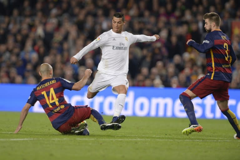 Real Madrid forward Cristiano Ronaldo (centre) vies with Barcelona defenders during their Spanish league "Clasico" match at the Camp Nou stadium in Barcelona on April 2, 2016