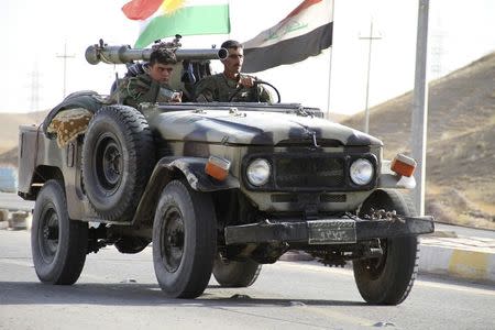 Members of Kurdish security forces travel in a vehicle during clashes with Sunni militant group Islamic State of Iraq and the Levant (ISIL) on the outskirts of Diyala June 14, 2014. REUTERS/Yahya Ahmad