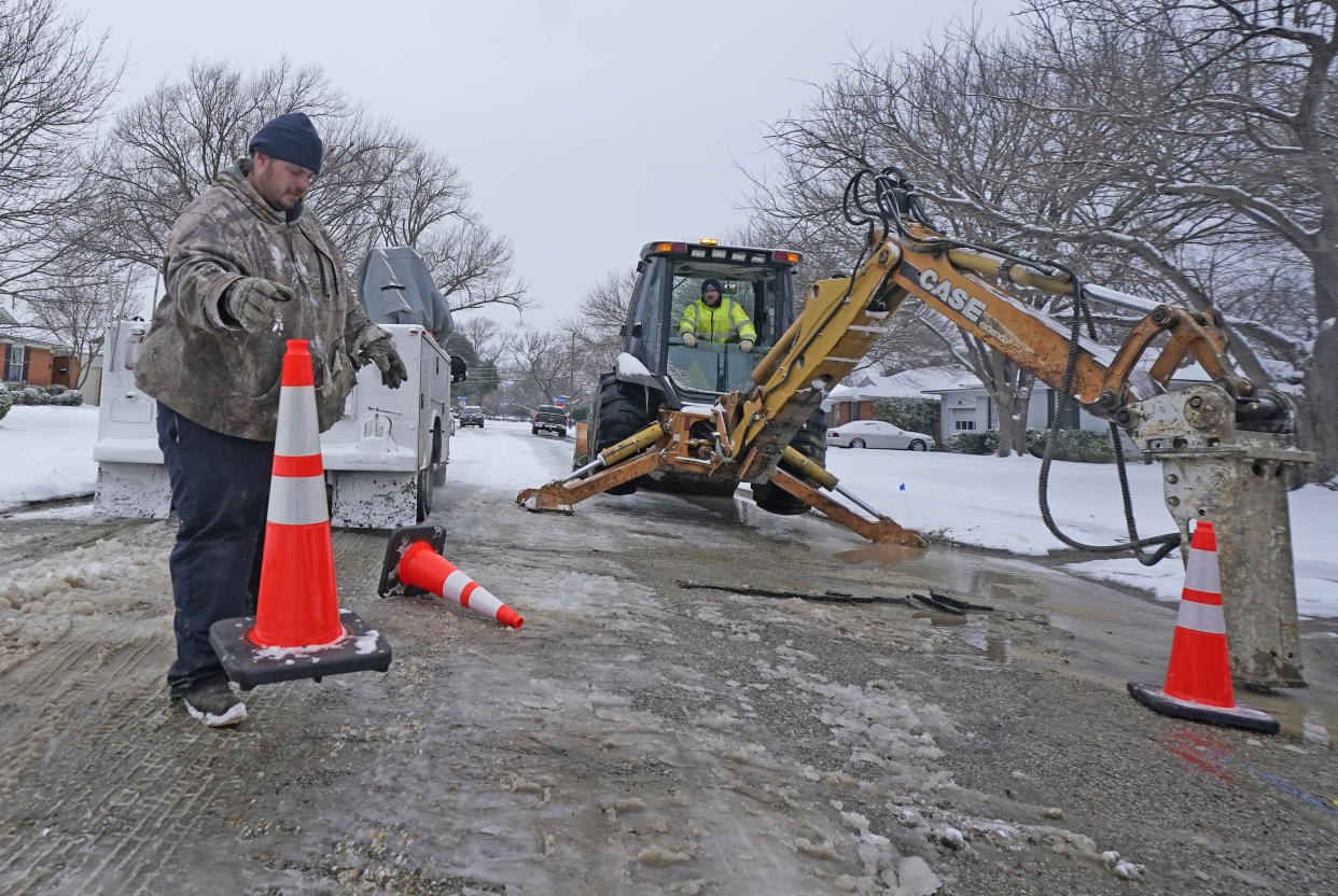City of Richardson workers prepare to work on a water main pipe that burst due to extreme cold in a neighborhood Wednesday, Feb. 17, 2021, in Richardson, Texas. Water service providers in Tennessee, Oklahoma, Texas and other states hit hard by frigid winter storms and mounting power outages are asking residents to restrict usage as reports of water main breaks, low pressure and busted pipes emerge. (AP Photo/LM Otero)