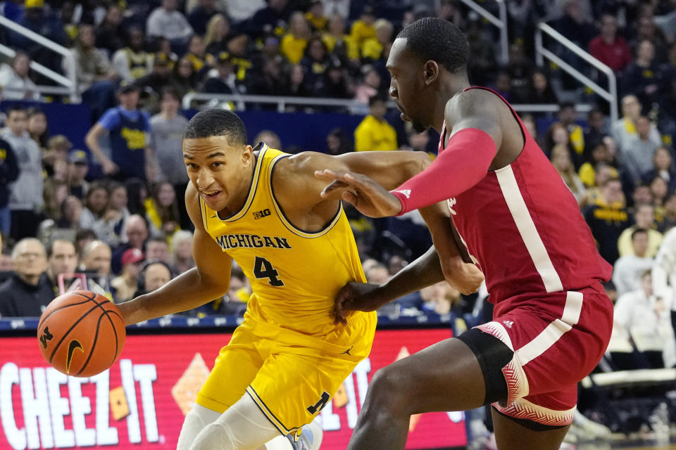 Michigan guard Nimari Burnett (4) drives as Nebraska forward Juwan Gary (4) defends during the second half of an NCAA college basketball game, Sunday, March 10, 2024, in Ann Arbor, Mich. (AP Photo/Carlos Osorio)