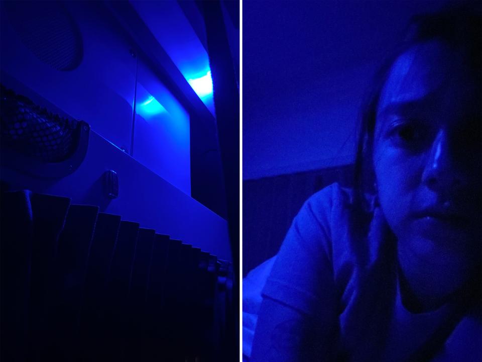 The author is seen in the dark with only the blue light on in the train bed