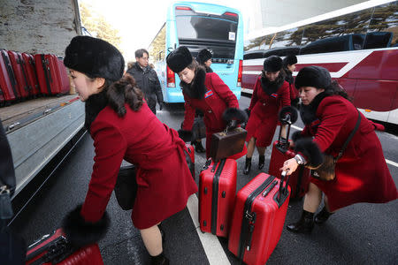 North Korean cheering squads carry suitcases upon their arrival at the Korean-transit office near the Demilitarized Zone in Paju, South Korea, February 7, 2018. REUTERS/Ahn Young-joon/Pool