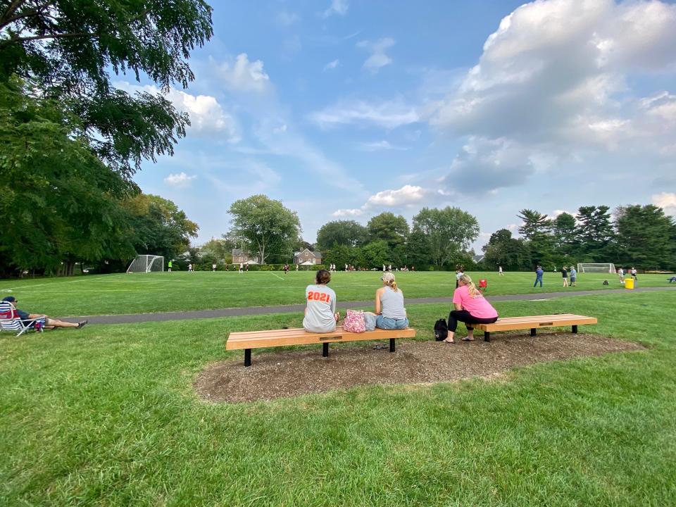 Parents watch a soccer game at Lower Merion High in Ardmore, Pa.