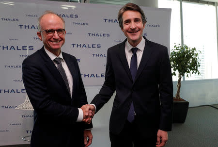 Patrice Caine, Chairman and Chief Executive Officer of Aerospace and defence group Thales, and Philippe Vallee, Chief Executive Officer of chipmaker Gemalto, shake hands before a news conference in Paris, France, December 18, 2017. REUTERS/Philippe Wojazer