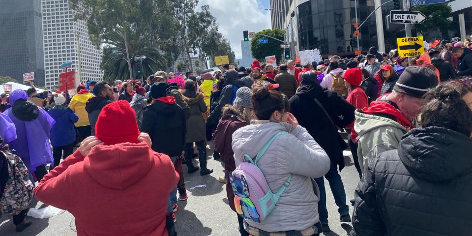 Picketers hold signs and chant outside LAUSD headquarters on March 21, 2023.