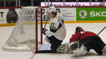 Adam Gaudette of the United States scores the second goal against Switzerland's keeper Leonardo Genoni during the Hockey World Championship quarterfinal match between Switzerland and USA in Helsinki, Finland, Thursday May 26, 2022. (AP Photo/Martin Meissner)