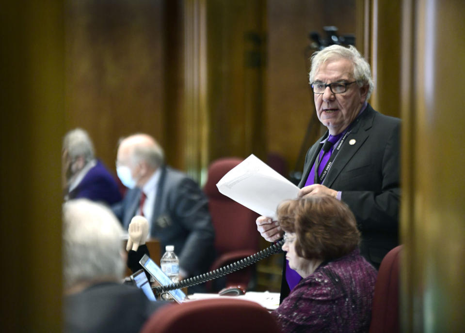 North Dakota Sen. Ray Holmberg, R-Grand Forks, goes through the list of 42 proposed appropriations in Senate Bill 2345 on the Senate floor at the state Capitol in Bismarck, N.D., in November 2021. Retired Republican state Sen. Holmberg has been charged with traveling to Europe with the intent of paying for sex with a minor and with receiving images depicting child sexual abuse, according to a federal indictment unsealed Monday, Oct. 30, 2023. (Mike McCleary/The Bismarck Tribune via AP)