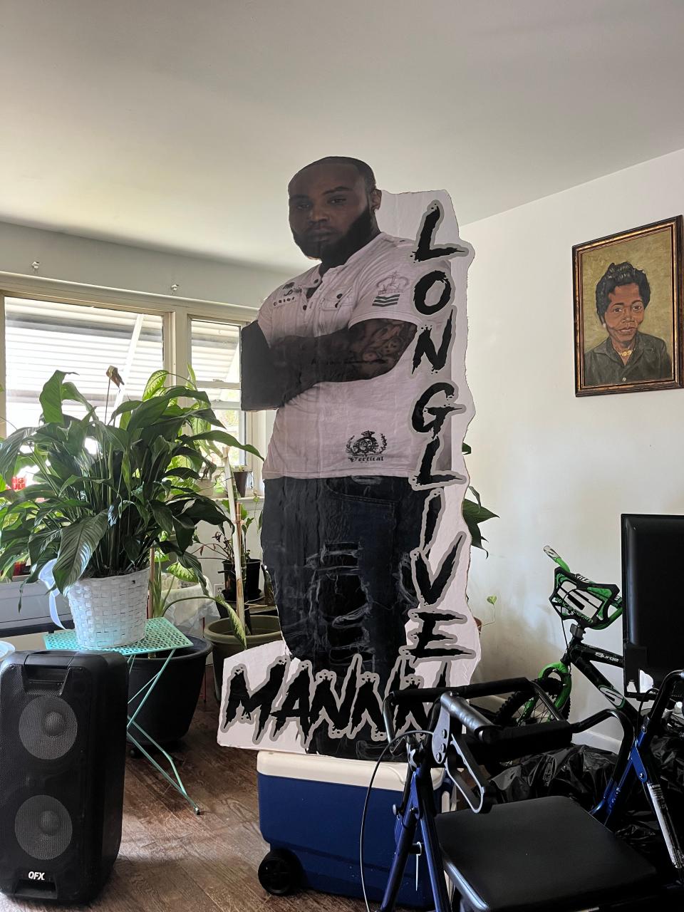 A cardboard cutout of Mannin Quarles, Sr., who was killed in a shooting on Sept. 1, 2023, in his mother's living room.