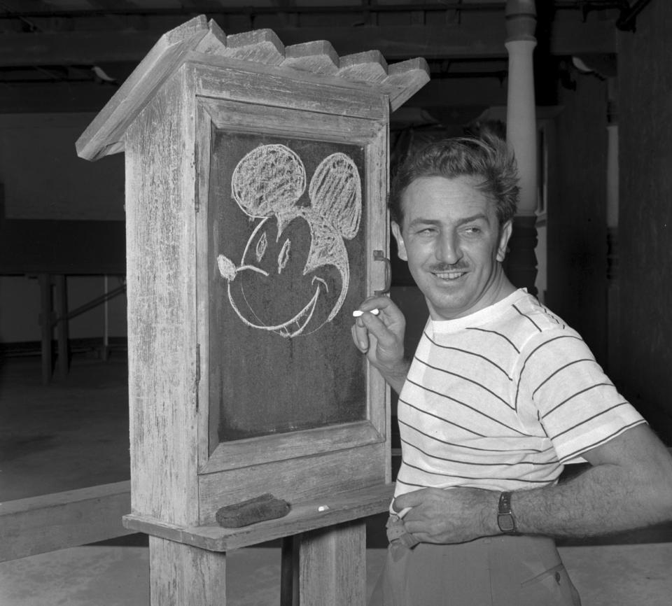 Walt Disney, the creator of Mickey Mouse, in 1941, drawing Mickey with chalk on a blackboard.