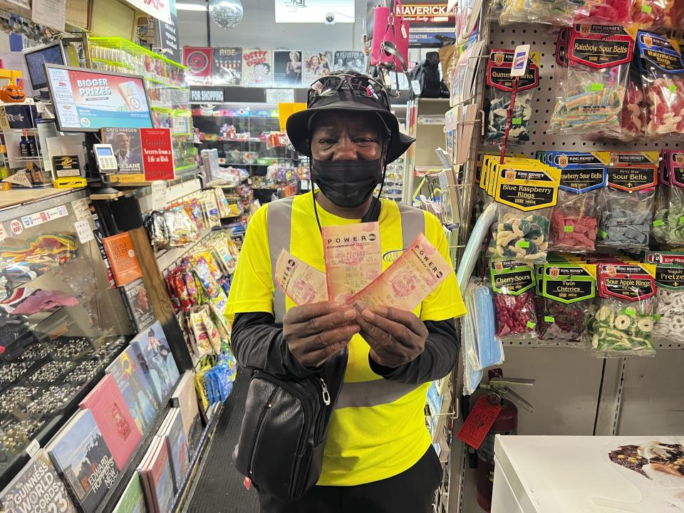 Chevy Johnson, a resident of Broward County, Fla., holds the three Powerball tickets she purchased in the hope of winning the jackpot of over $1 billion, in Fort Lauderdale, Fla., on Monday, Oct. 2, 2023. She said a win would make her "the happiest person in the world." (AP Photo/Daniel Kozin)