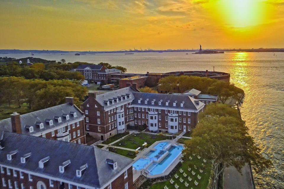 Aerial view of the QC NY Spa on Governors Island with view of Statue of Liberty