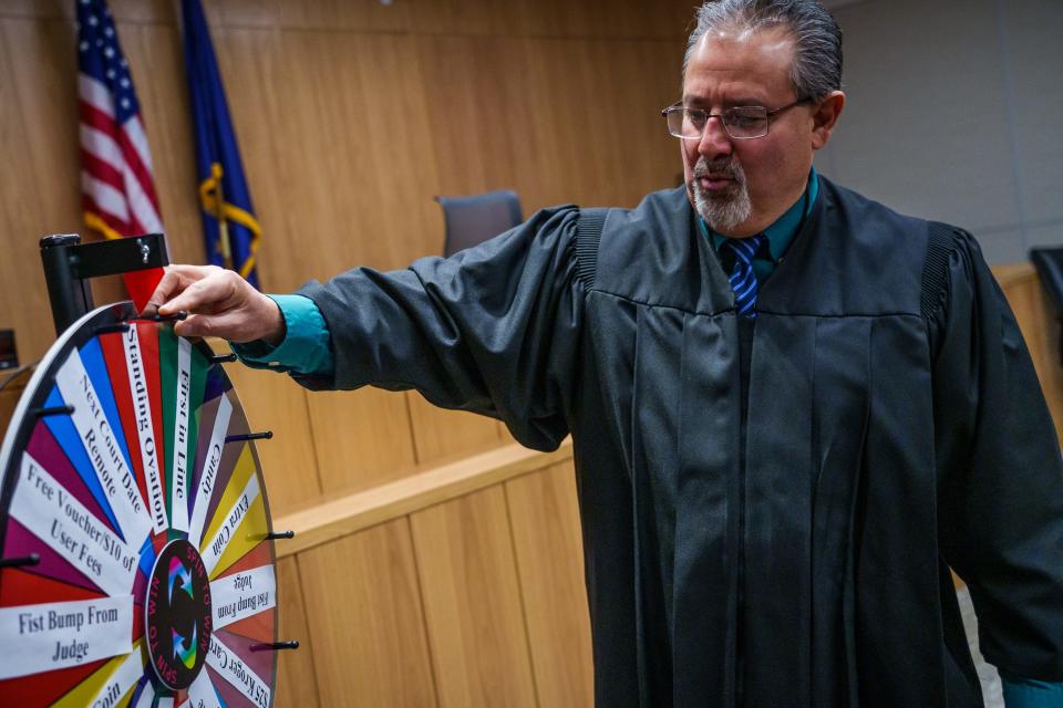 Marion Superior Judge Jose Salinas speaks Thursday, Feb. 16, 2023, about a new and colorful "spin to win" wheel that sits inside his courtroom. Drug court participants who have a good week get called up to the front of the court to spin the wheel. Prizes include candy, a fist bump with the judge, a standing ovation and -- the jackpot -- a $25 Kroger gift card. "Many times our clients, this is the first time they're being acknowledged in a good way," Salinas said. "We're always looking for things that are new. I think it's cool. I think it's important."