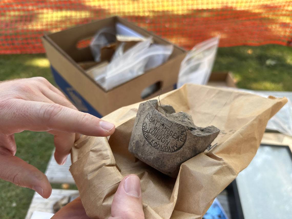 Dan Everhart, Idaho State Historic Preservation Office outreach historian, points to a maker’s mark on the base of a crucible, used to process and refine ore samples. Such maker’s marks allow historians to date the artifact based on when the company was in business.