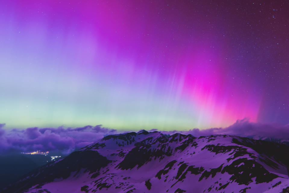 TOPSHOT - Northern lights or aurora borealis illuminate the night sky over Fusch an der Großglocknerstraße, near Zell am See, during a geomagnetic storm on May 11, 2024. The planet is experiencing its first 