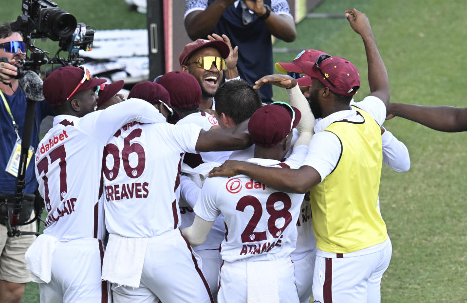 West Indies players celebrate after defeating Australia on the 4th day of their cricket test match in Brisbane, Sunday, Jan. 28, 2024. (Darren England/AAP Image via AP)