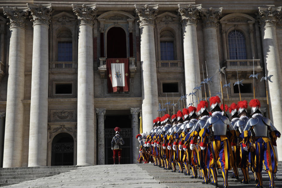 Swiss Guards march in front of Peter's Basilica at the Vatican, Tuesday, Dec. 25, 2018. Monday's late night Mass was the first major event of the Christmas season, followed by Francis' noon Urbi et Orbi (To the city and the world) blessing on Christmas day. (AP Photo/Alessandra Tarantino)