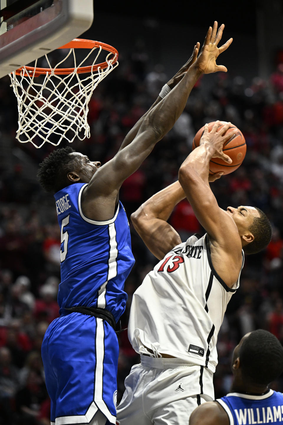 San Diego State forward Jaedon LeDee (13) shoots over BYU forward Gideon George (5) during the second half of an NCAA college basketball game Friday, Nov. 11, 2022, in San Diego. (AP Photo/Denis Poroy)