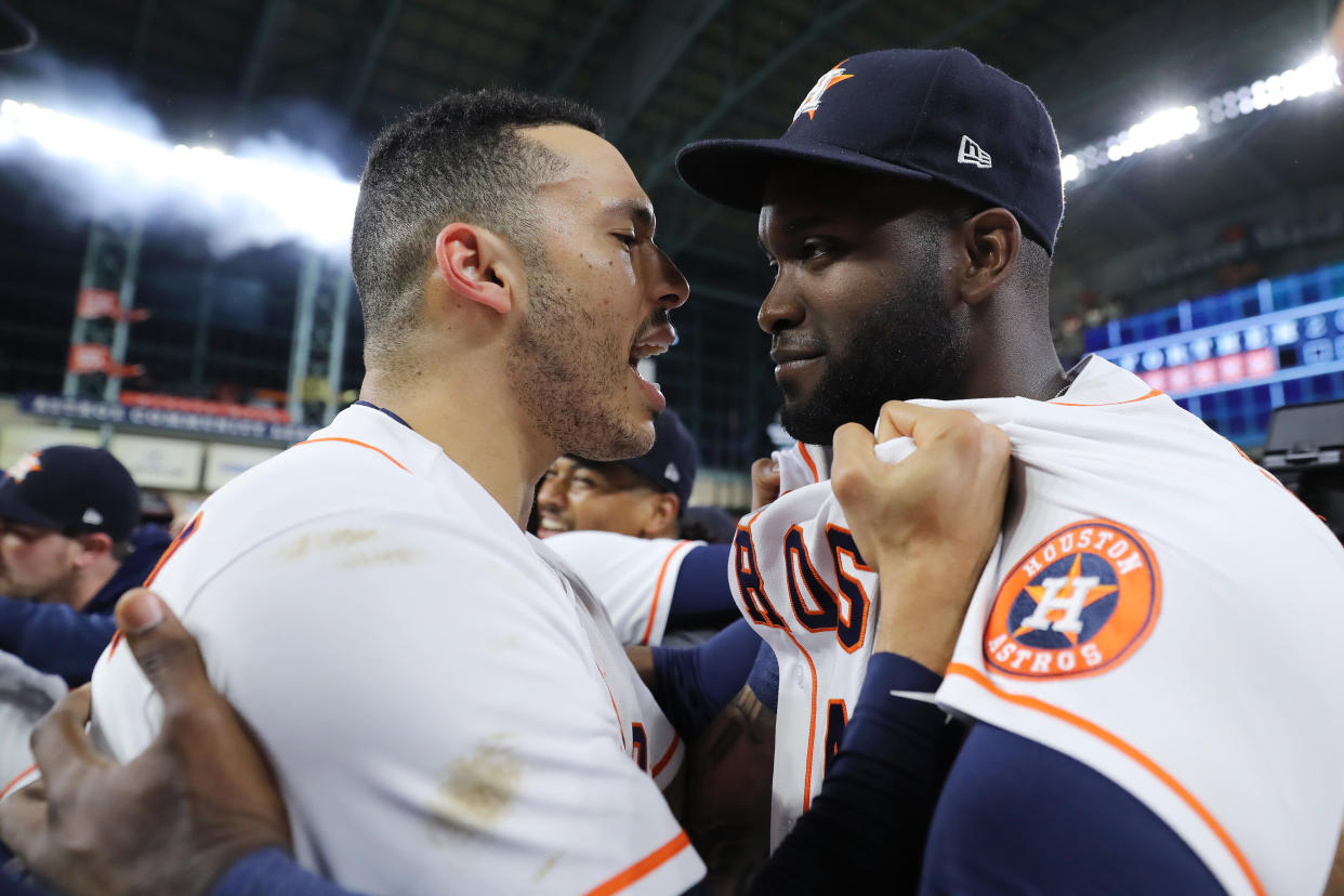 Carlos Correa and Yordan Alvarez share a moment of celebration after Alvarez's four-hit game helped the Astros clinch a World Series berth.