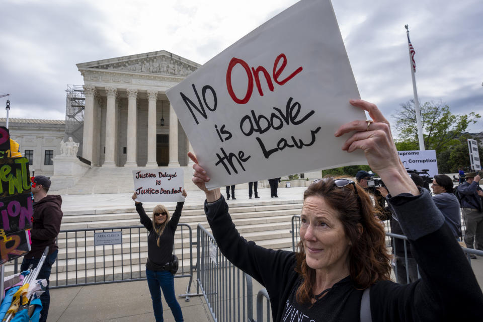 Diana Neary of Minneapolis, joins other protesters demonstrating outside the Supreme Court as the justices hear arguments over whether Donald Trump is immune from prosecution in a case charging him with plotting to overturn the results of the 2020 presidential election, on Capitol Hill in Washington, Thursday, April 25, 2024. (AP Photo/J. Scott Applewhite)