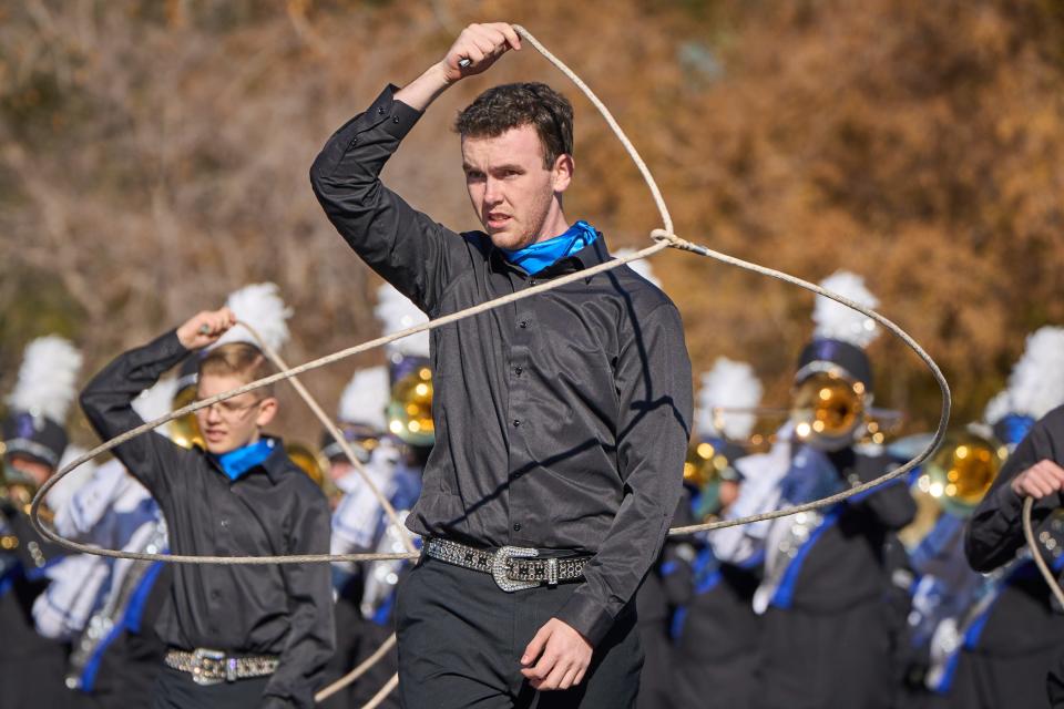 Dec 17, 2022; Phoenix, AZ, USA; A member of the Catalina Foothills Falcon Band spins a lasso around himself during the Fiesta Bowl Parade in Phoenix on Saturday, Dec. 17, 2022. Mandatory Credit: Alex Gould/The Republic