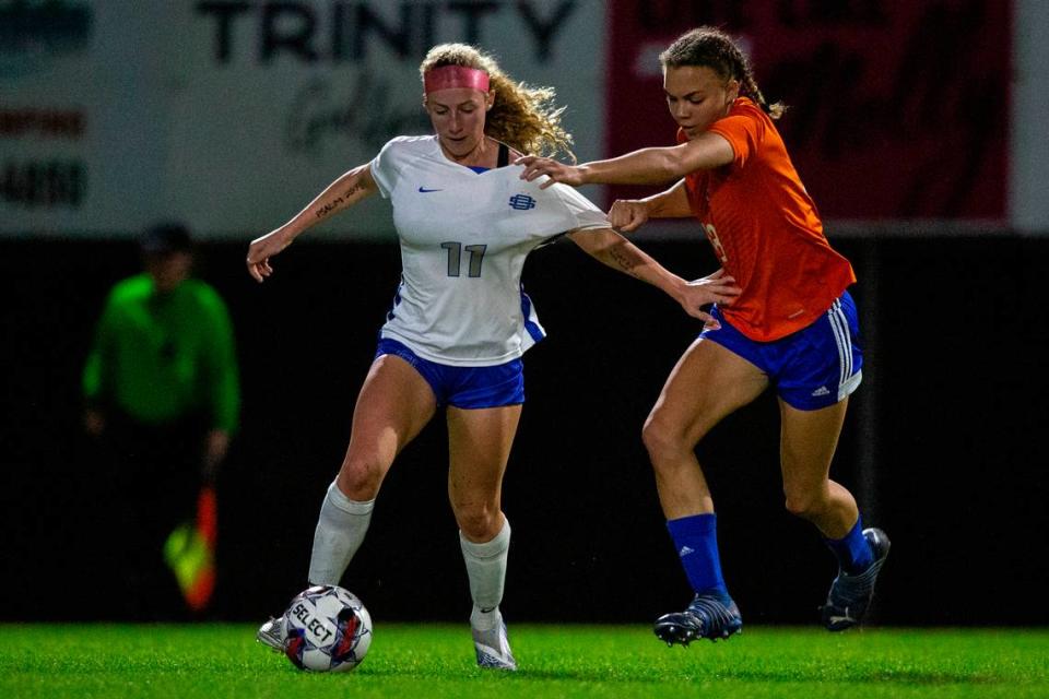 Gulfport’s Abigail Badurak and Ocean Springs’ Parker St. Amant fight for the ball during the 6A South State Championship game in Gulfport on Tuesday, Jan. 31, 2023.