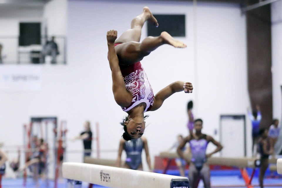 Simone Biles works on her routine on the balance beam during training at the Stars Gymnastics Sports Center in Katy, Texas, Monday, Feb. 5, 2024. Biles begins preparations for the Paris Olympics when she returns to competition at the U.S. Classic in Hartford, Connecticut on Saturday. Biles, who cited mental health concerns while removing herself from several competitions at the Tokyo Olympics, says she is better prepared for the pressure competing presents this time around. (AP Photo/Michael Wyke)