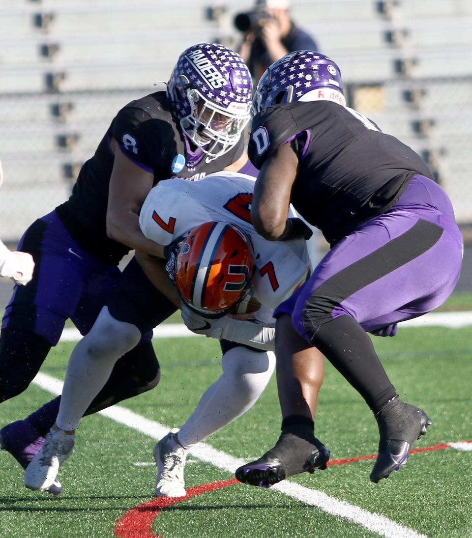 Mount Union's Rossy Moore, left, and Duke Hill, right, sack Utica quarterback Braeden Zenelovic during an NCAA Division IIII football second-round playoff game at Kehres Stadium on Saturday, November 26, 2022.