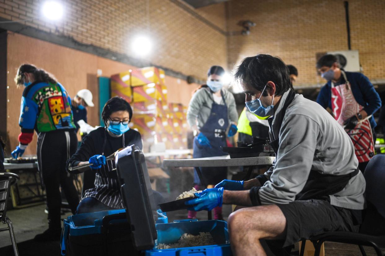 Volunteers wearing masks are seen putting together meals in a kitchen in an underground carpark run by the Hare Krishna on May 5, 2020, in London, England. The Hare Krishna are preparing and distributing meals to vulnerable people and communities across London in light of the coronavirus pandemic.