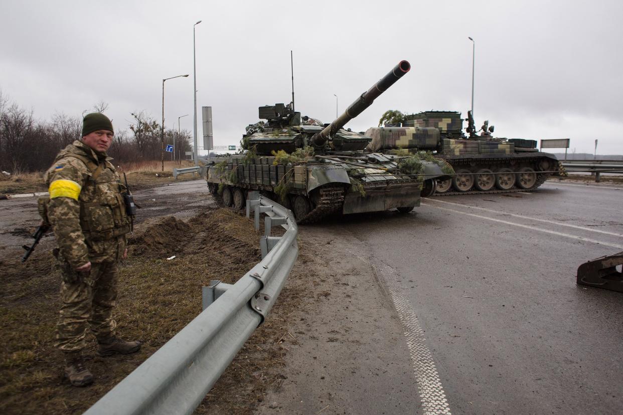 Ukrainian servicemen take an APC for repairs on March 3, 2022, in Sytniaky, Ukraine, west of the capital. Russia continues its assault on Ukraine's major cities, including the capital Kyiv, a week after launching a large-scale invasion of the country.