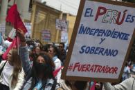 People march against the 52nd Organization of American states (OAS) General Assembly as it's held in Lima, Peru, Thursday, Oct. 6, 2022. The sign reads in Spanish "Peru is independent and sovereign." (AP Photo/Guadalupe Pardo)