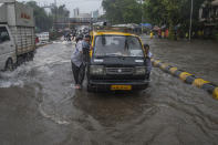 MUMBAI, INDIA - JULY 16: People push the taxi in the waterlogged street due to heavy rain at Gandhi Market, sion, on July 16, 2020 in Mumbai, India. (Photo by Pratik Chorge/Hindustan Times via Getty Images)