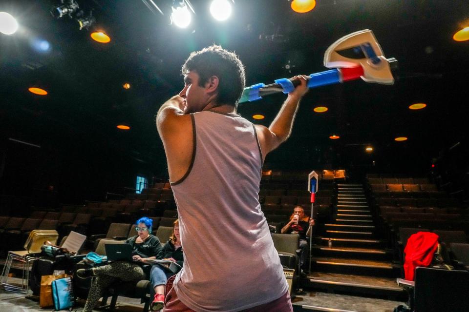 Actor Daniel Perkins tries out one of the props during a rehearsal for Spectrum Theatre Ensemble's 4th Annual Neurodiversity New Play Festival.