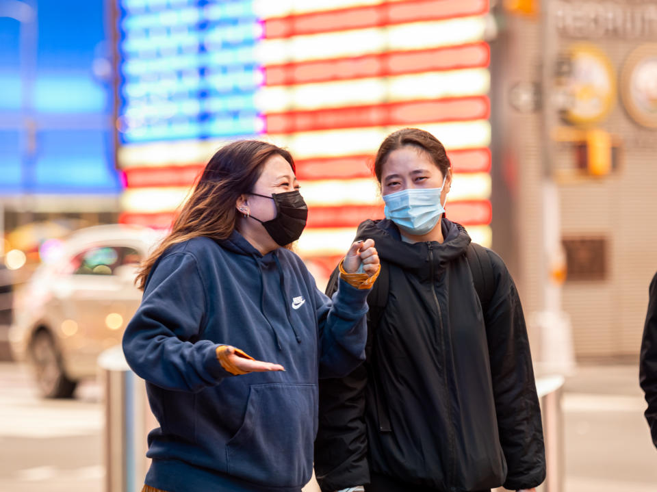 NEW YORK, NEW YORK - OCTOBER 28: People wear face masks by the U.S. Armed Forces Recruiting Station in Times Square as the city continues the re-opening efforts following restrictions imposed to slow the spread of coronavirus on October 28, 2020 in New York City. The pandemic has caused long-term repercussions throughout the tourism and entertainment industries, including short-term and permanent closures of historic and iconic venues, and costing the city and businesses billions in revenue.  (Photo by Noam Galai/Getty Images)