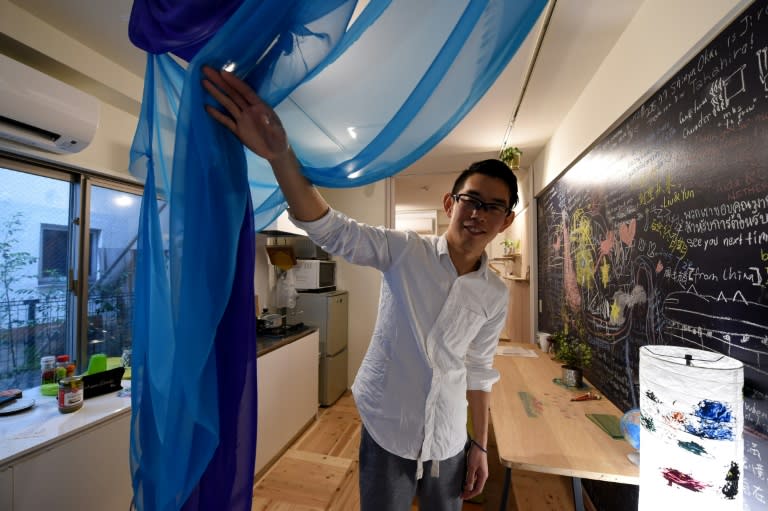 An Airbnb host displays his guest room at his room in Tokyo, but the site's fastest-growing market is also becoming the next flashpoint in a global battle over the sharing economy