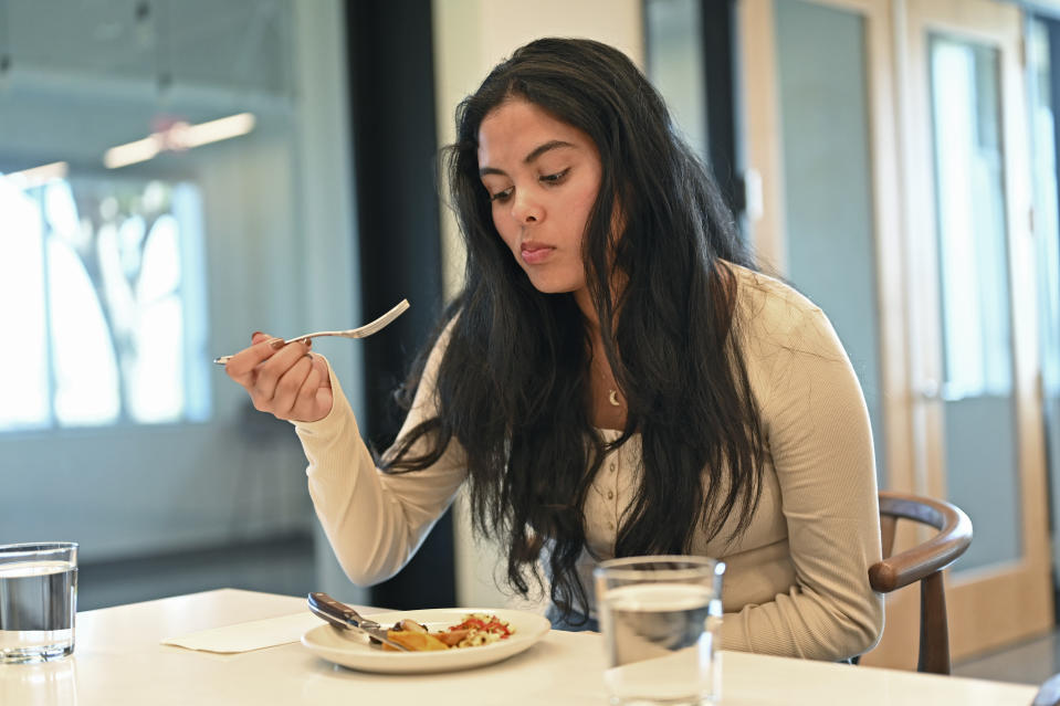 Tayeba Chowdhury tastes cultivate chicken at GOOD Meat's Alameda, Calif., headquarters on Thursday, Sept. 28, 2023. The company's cultivated chicken, which is grown from animal cells, is approved for sale in the United States and Singapore. (AP Photo/Noah Berger)