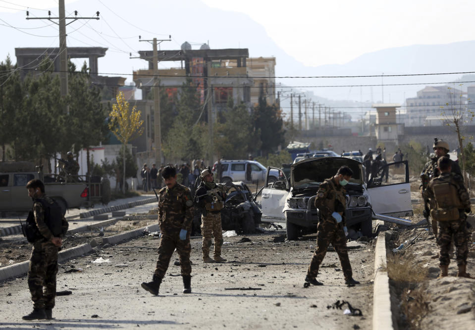 Afghan security personnel gather at the site of car bomb attack in Kabul, Afghanistan, Wednesday, Nov. 13, 2019. A car bomb detonated in the Afghan capital of Kabul during Wednesday's morning commute, killing several people, officials said. (AP Photo/Rahmat Gul)