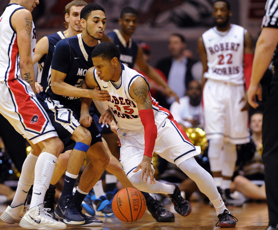 Robert Morris' Karvel Anderson (15) is fouled by Mount St. Mary's' Julian Norfleet during the first half of the Northeastern Conference championship NCAA college basketball game on Tuesday, March 11, 2014, in Coraopolis, Pa. (AP Photo/Don Wright)