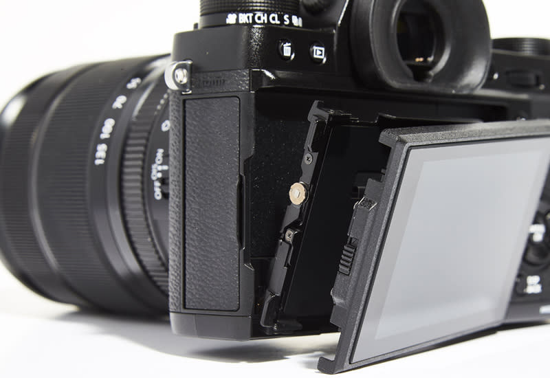 The X-T2's rear LCD can flip upwards as well as outwards, so it can still face you in portrait orientation.